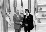 Elvis Presley met President Richard Nixon in the Oval Office of The White House on December 21, 1970. The Nixon Library & Birthplace sells a number of souvenir items with this photo and the caption, 'The President & the King'.